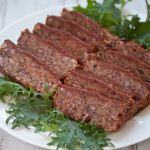 Sliced vegan quinoa loaf with clove spiced date sauce